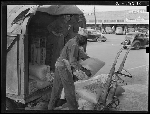 Unloading wholesale grocery wagon. San Augustine, Texas
