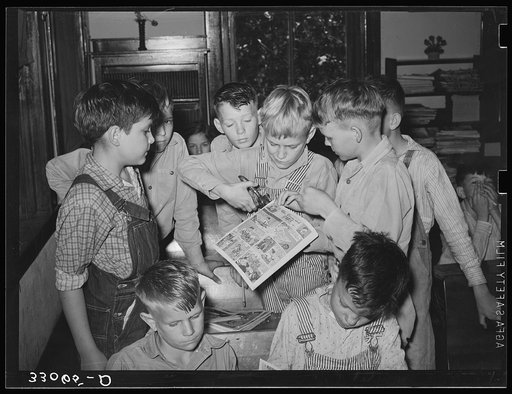 Making books of comic strips. Grade school, San Augustine, Texas