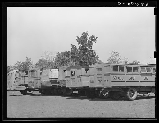 Untitled photo, possibly related to: Lineup of school buses near Wells, Texas