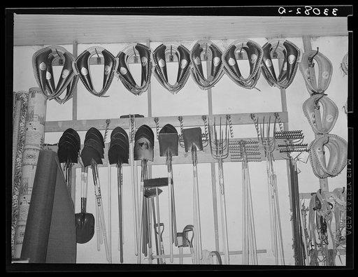Horse collars, spades and rakes, etc. in hardware store. San Augustine Texas