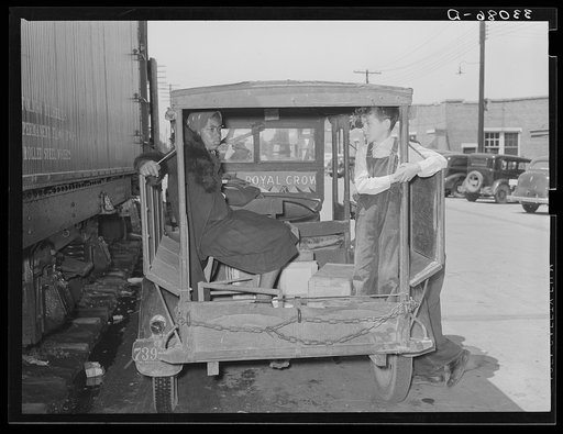 Young son of strawberry grower with one of the Negro pickers in town on Saturday afternoon. Hammond, Louisiana