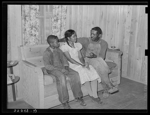FSA (Farm Security Administration) family in living room of home. Sabine Farms, Marshall, Texas
