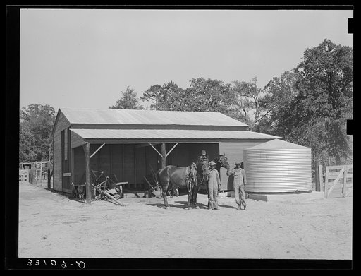 Team in front of barn unit on Sabine Farms, Marshall, Texas