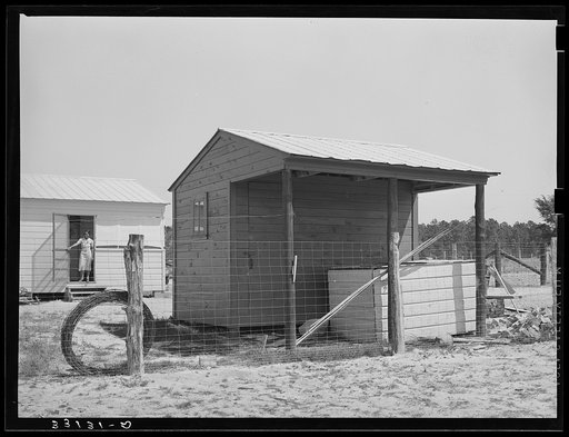 Untitled photo, possibly related to: Shed and corner of house on farm unit. Sabine Farms, Marshall, Texas