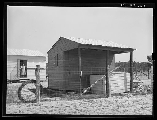 Shed and corner of house on farm unit. Sabine Farms, Marshall, Texas
