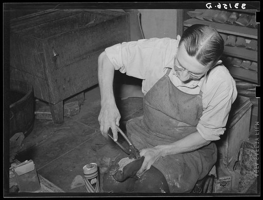 Untitled photo, possibly related to: Bootmaker putting last and sole into upper part of boot. Boot shop, Alpine, Texas