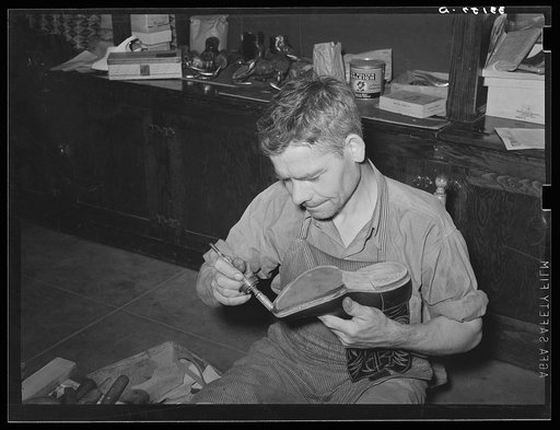 Applying glue before putting on outer sole of boot. Cowboy boot shop, Alpine, Texas