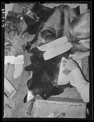 Cutting out uppers of boots. Cowboy boot shop, Alpine, Texas