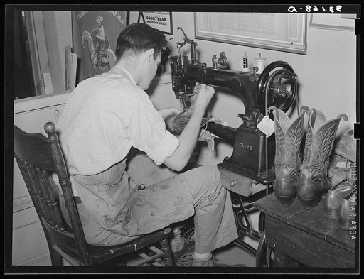 Repairing cowboy boots in boot shop. Alpine, Texas