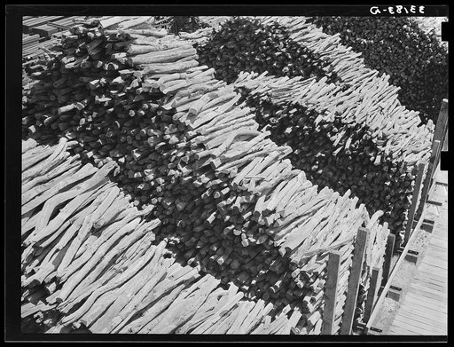 Stacks of wood in railroad yard. Marshall, Texas