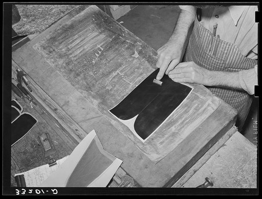 Smoothing out wrinkles after gluing lining into upper part of boots. Bootmaking shop, Alpine, Texas