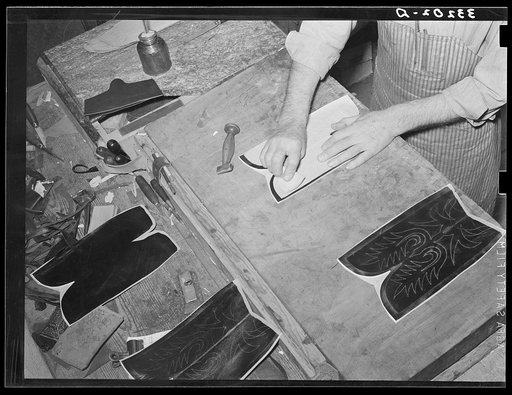 Transferring pattern for stitching on the uppers of the boots. Bootmaking shop, Alpine, Texas