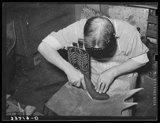Tracing outline of sole of boot on sole leather. Boot shop, Alpine, Texas