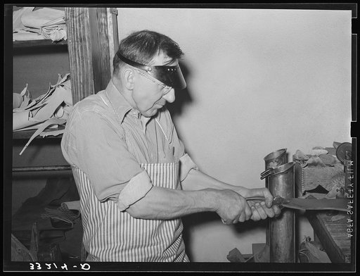 Skiving sole leather by machine. Boot shop, Alpine, Texas