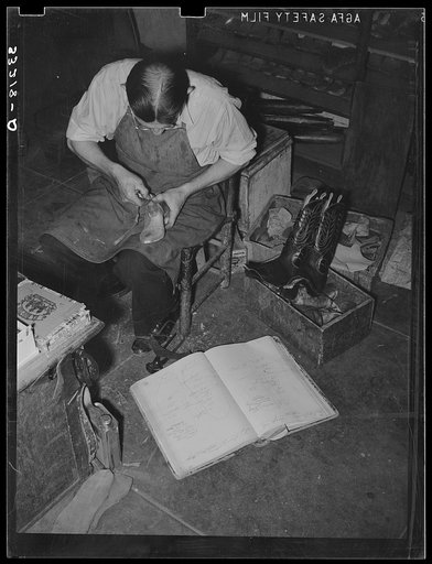 Measuring a standard last to see how it conforms to individual measurement. Cowboy boot shop, Alpine, Texas