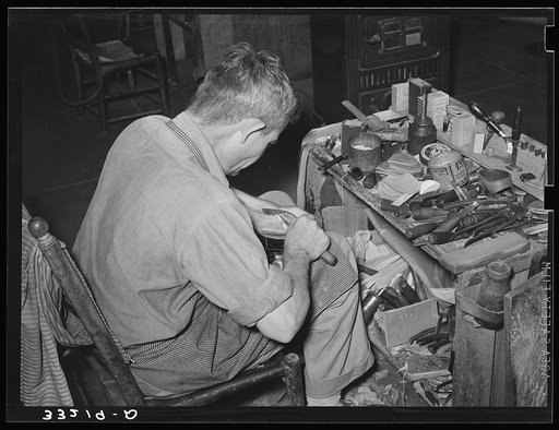 Bootmaker at work showing his workbench. Cowboy boot shop, Alpine, Texas
