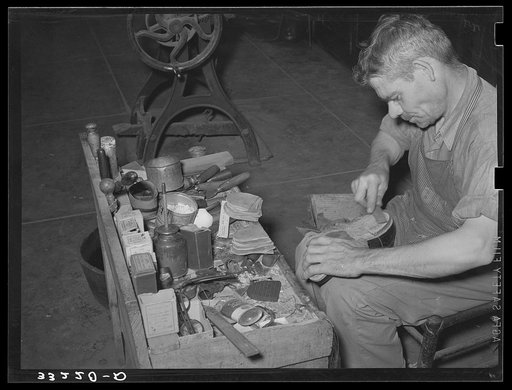 Leather which forms the heel is applied in layers and is filed down for accurate shaping. Boot shop, Alpine, Texas