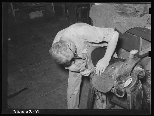 Repairing saddle. Alpine, Texas, saddle shop