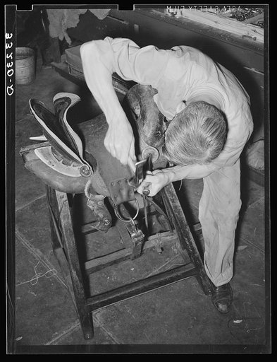 Rivet work in saddle repair shop. Alpine, Texas