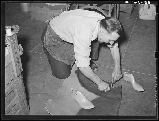 Cutting out of the sole of the boot from pattern traced from last. Bootmaking shop, Alpine, Texas