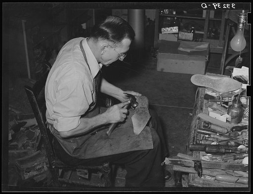First shaping of leather sole of cowboy boot. Boot shop, Alpine, Texas