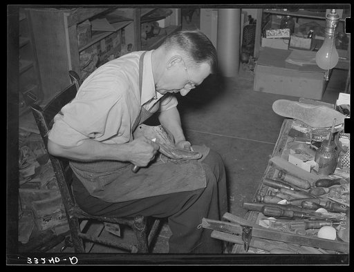 Trimming inner sole to conform to last. Cowboy bootmaking shop, Alpine, Texas