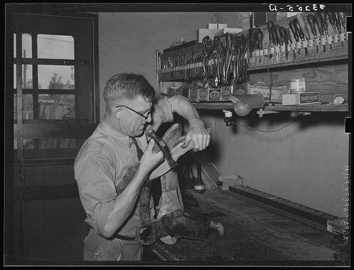 Repairing a saddle. Saddle shop, Alpine, Texas