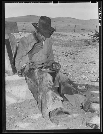 Mexican cowboy eating dinner after the roundup. Cattle ranch near Marfa, Texas