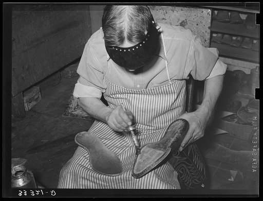 Applying cement to boot before attaching outer sole. Bootmaking shop, Alpine, Texas