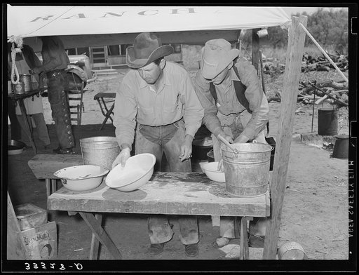 Cowboys of the SMS Ranch washing up for dinner. Ranch near Spur, Texas