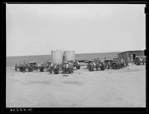 Tractors clustered around gasoline tanks on 4900 acre farm near Ralls, Texas
