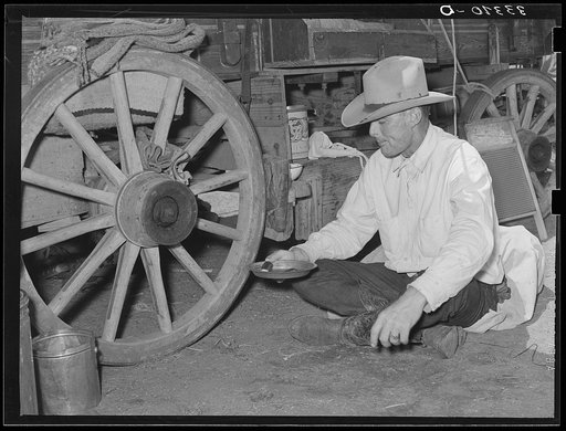Cowboy eating dinner by the chuck wagon on SMS Ranch near Spur