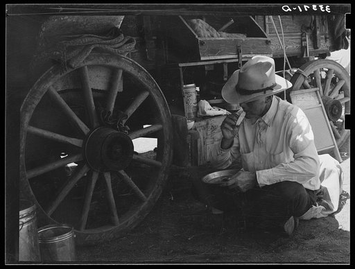 Untitled photo, possibly related to: Cowboy eating dinner by the chuck wagon on SMS Ranch near Spur