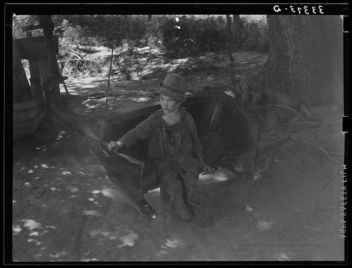 Untitled photo, possibly related to: Son of WPA (Works Progress Administration/Work Projects Administration) worker swinging. The father is a former tenant farmer, now on WPA. These are potential and probable migrants. Webbers Falls, Oklahoma