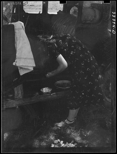 Untitled photo, possibly related to: Migrants loading rear deck of automobile while camped near Prague, Oklahoma. Lincoln County, Oklahoma