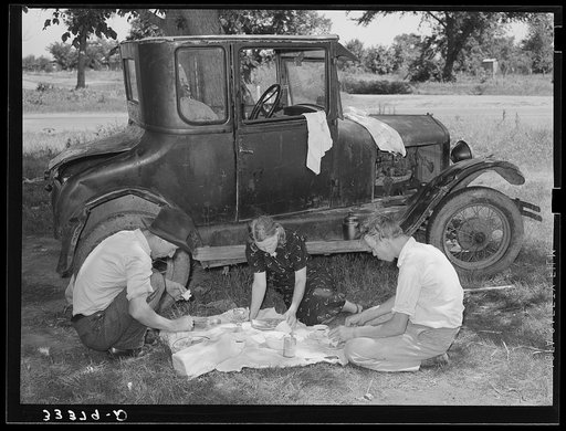 Untitled photo, possibly related to: Migrant workers eating dinner by the side of their car while they are camped near Prague, Oklahoma. Lincoln County