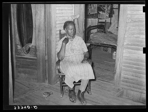 Mother of Negro agricultural day laborer on porch of her home. She was crippled with rheumatism. Muskogee County, Oklahoma