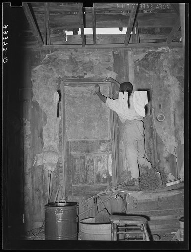 Room in house of Negro agricultural day laborer. Note hole in roof and boarded-up door. Muskogee County, Oklahoma