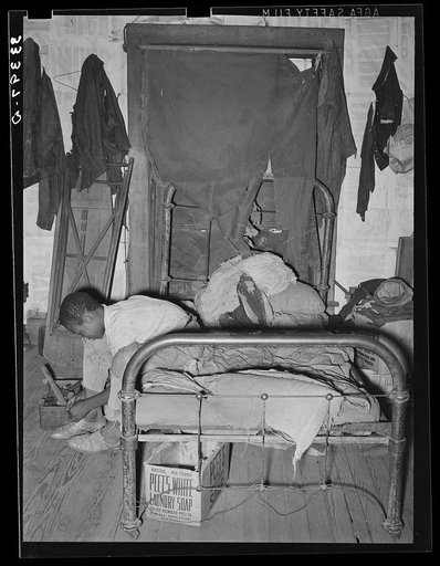 Untitled photo, possibly related to: Negro agricultural day laborer putting on his shoes. Muskogee, Muskogee County, Oklahoma