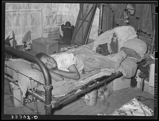 Negro agricultural day laborer taking a nap in his home. Muskogee, Oklahoma. Muskogee County