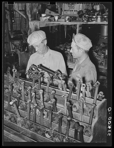 Migrant steeple-jack buying a replacement connecting rod at secondhand automobile parts store. Prague, Oklahoma, Lincoln County