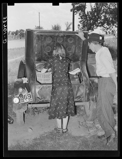 Migrants loading rear deck of automobile while camped near Prague, Oklahoma. Lincoln County, Oklahoma