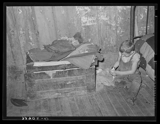 Son of agricultural day laborer living near Webbers Falls, Oklahoma. The father with his son and daughter lived in this desolate two-room shack. Muskogee County, Oklahoma