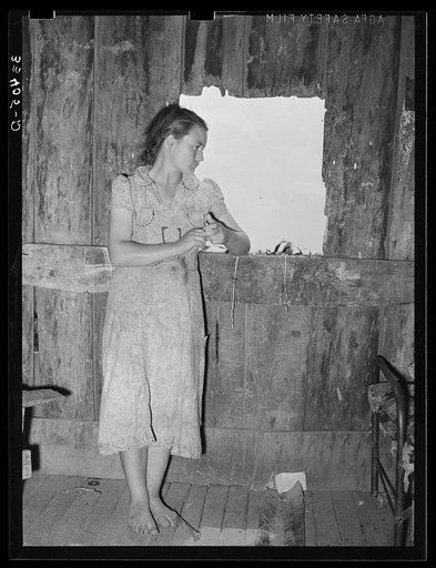 Daughter of agricultural day laborer looking out the unshuttered window of the desolate shack which was her home. She had never attended school. Her attitude was one of utter hopelessness; she was listless and completely untouched and uninterested in any living thing. Webbers Falls, Oklahoma