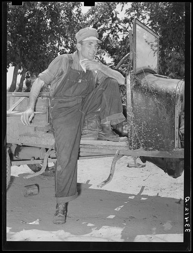 Agricultural day laborer wiping the sweat from his neck after his return home from chopping cotton.This man had once been a tenant farmer and had quit farming because of repeated crop failures and inability to secure good farming land; he then became a day laborer, his entire family working with him