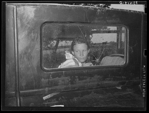Migrant worker looking through back window of automobile near Prague, Oklahoma. Lincoln County, Oklahoma