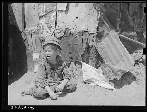 Son of agricultural day laborer in front of tent home near Webbers Falls, Oklahoma. Muskogee County, Oklahoma
