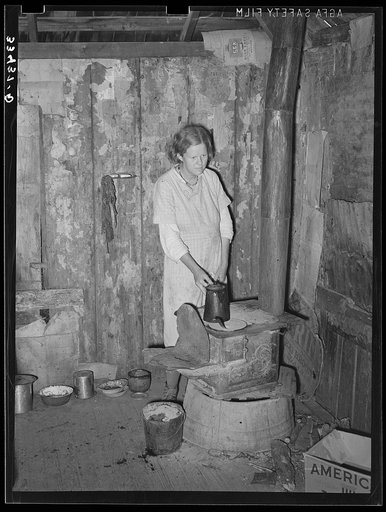 Wife of day laborer in kitchen corner of one-room shack near Warner, Oklahoma. Muskogee County