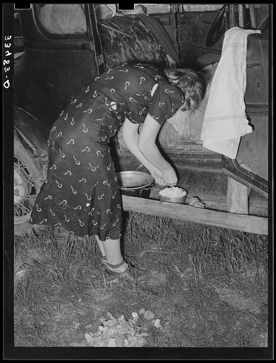 Untitled photo, possibly related to: Migrant woman peeling potatoes on running board of car while camped near Prague, Oklahoma. Lincoln County, Oklahoma