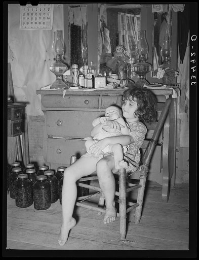Daughter of white tenant farmer taking care of her baby sister in her home in McIntosh County, Oklahoma